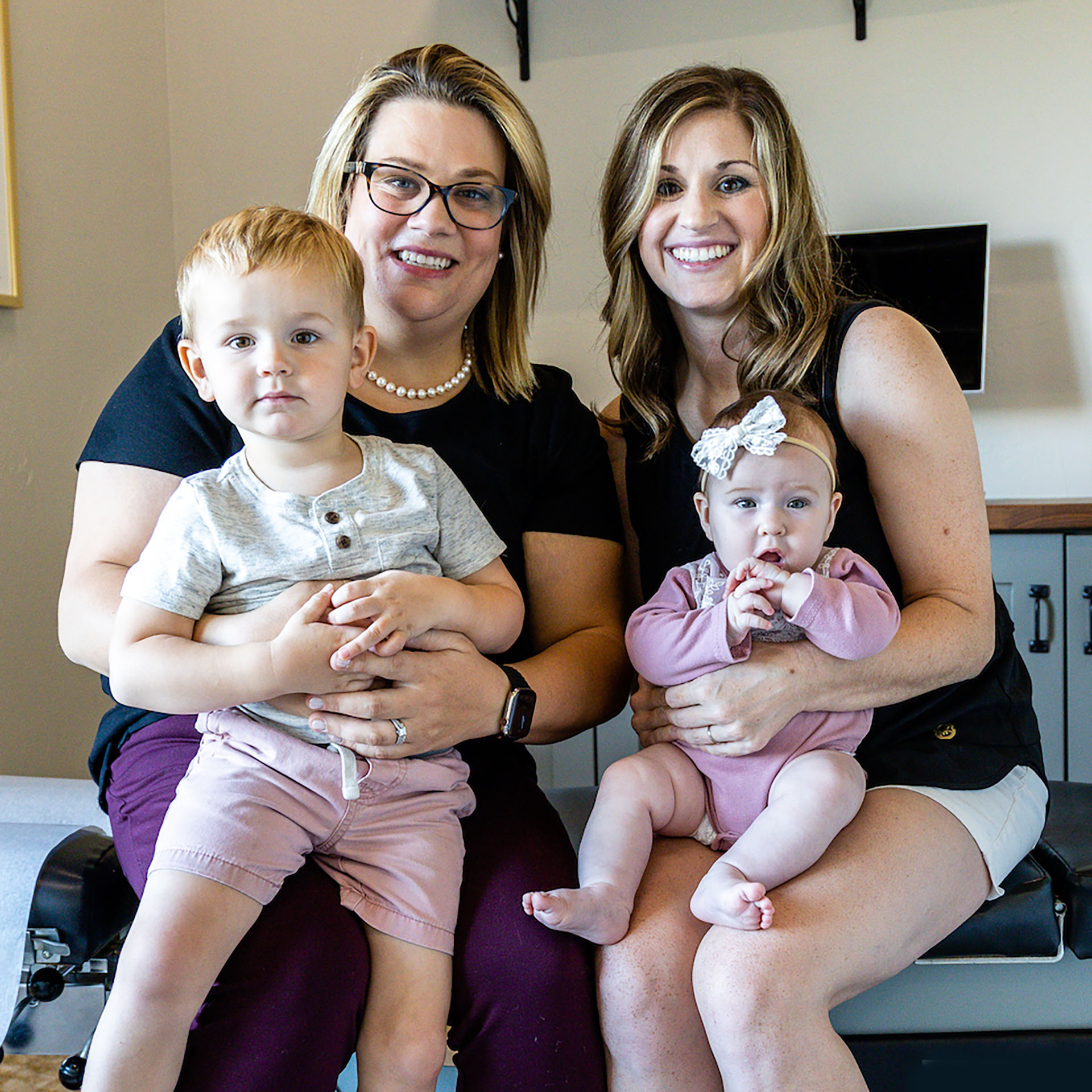 A chiropractor treating a patient laying on a chiropractic table.